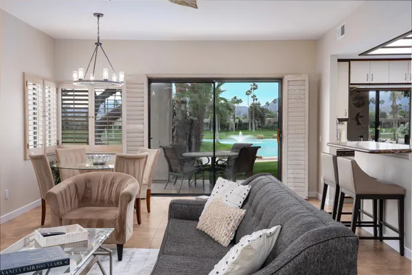 a living room with furniture and a chandelier