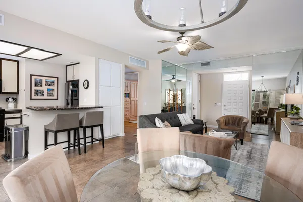 a living room with furniture and a chandelier