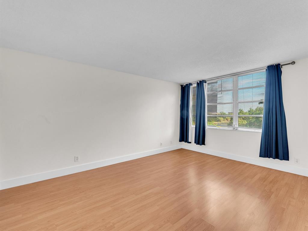 6901 Environ Boulevard, Unit 4D Lauderhill, FL 33319 - Photo 14 of 23 a view of an empty room with a window and a kitchen