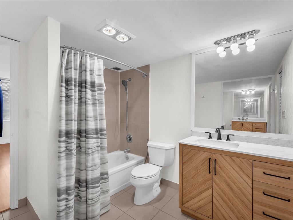 6901 Environ Boulevard, Unit 4D Lauderhill, FL 33319 - Photo 16 of 23 a bathroom with a toilet a sink and a mirror