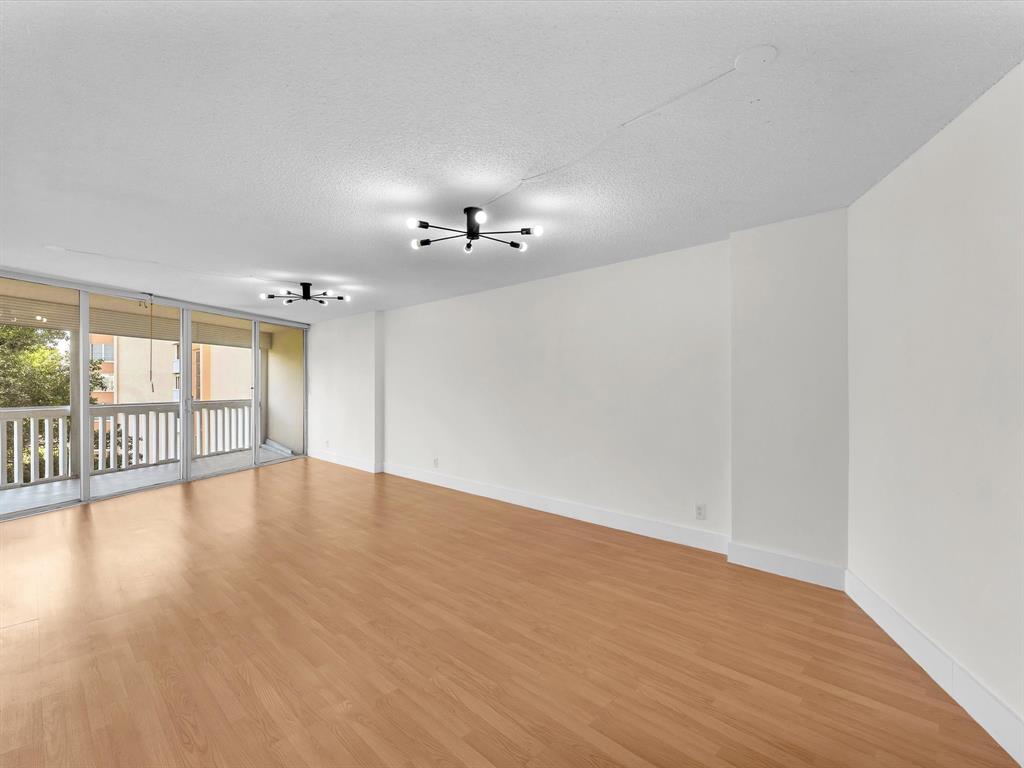 6901 Environ Boulevard, Unit 4D Lauderhill, FL 33319 - Photo 2 of 23 a view of an empty room with wooden floor and a window