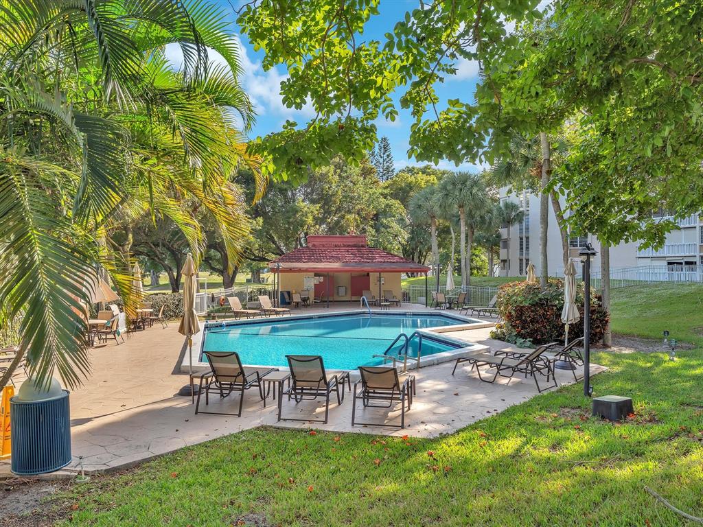 6901 Environ Boulevard, Unit 4D Lauderhill, FL 33319 - Photo 21 of 23 a view of a table and chairs in the garden