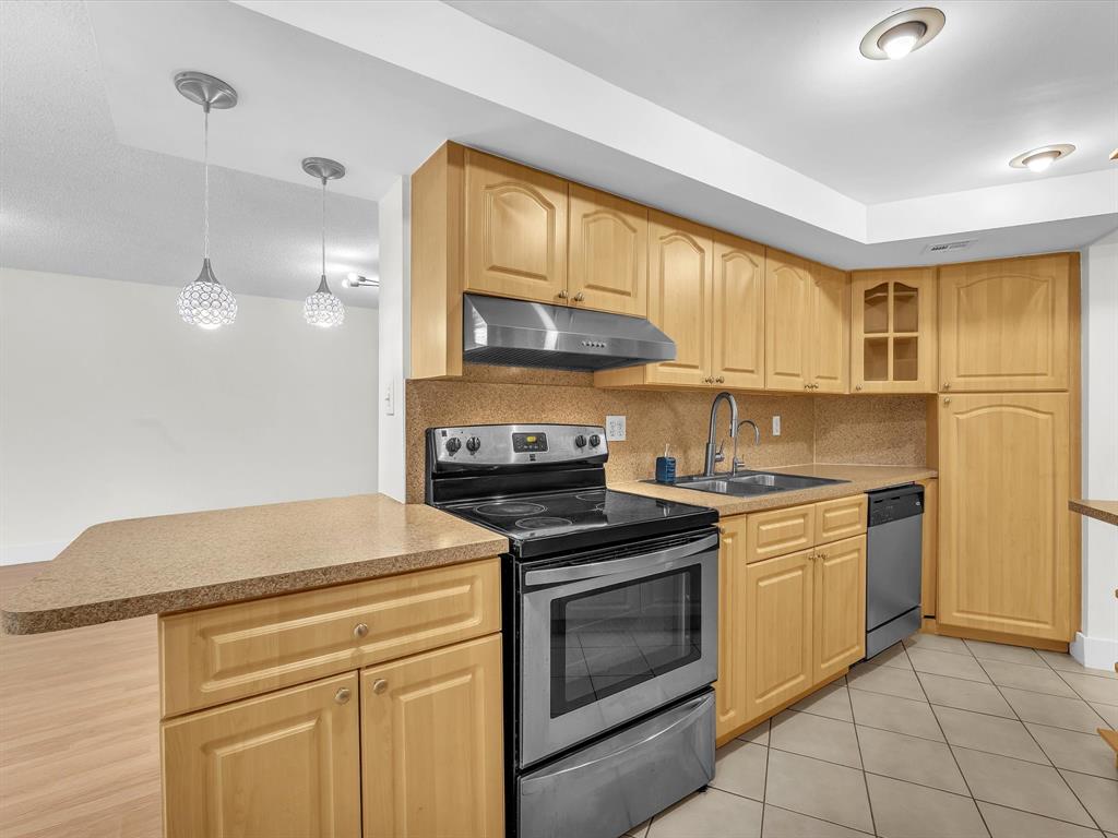 6901 Environ Boulevard, Unit 4D Lauderhill, FL 33319 - Photo 8 of 23 a kitchen with a stove a sink and a refrigerator