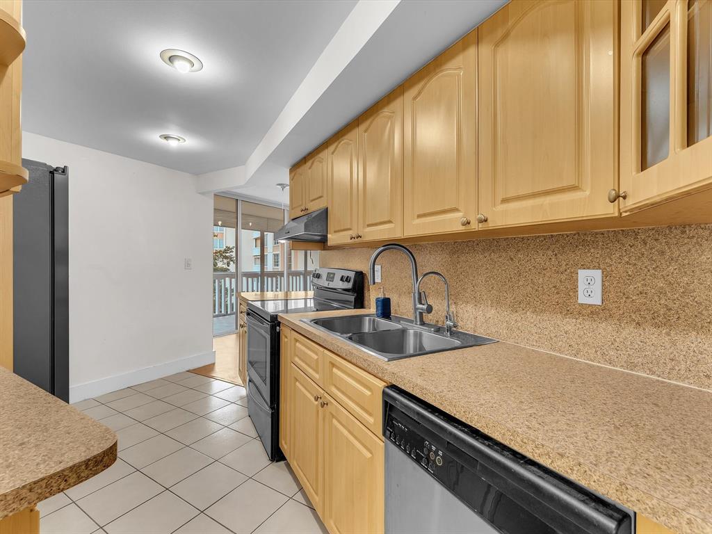 6901 Environ Boulevard, Unit 4D Lauderhill, FL 33319 - Photo 9 of 23 a kitchen with stainless steel appliances granite countertop a sink and cabinets