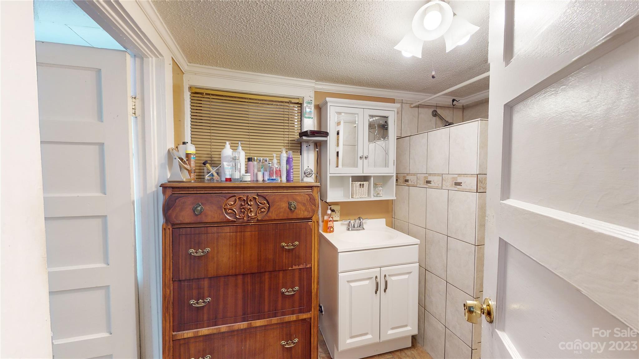 57 Lamar Street Marion, NC 28752 - Photo 15 of 48 a kitchen with a refrigerator and cabinets
