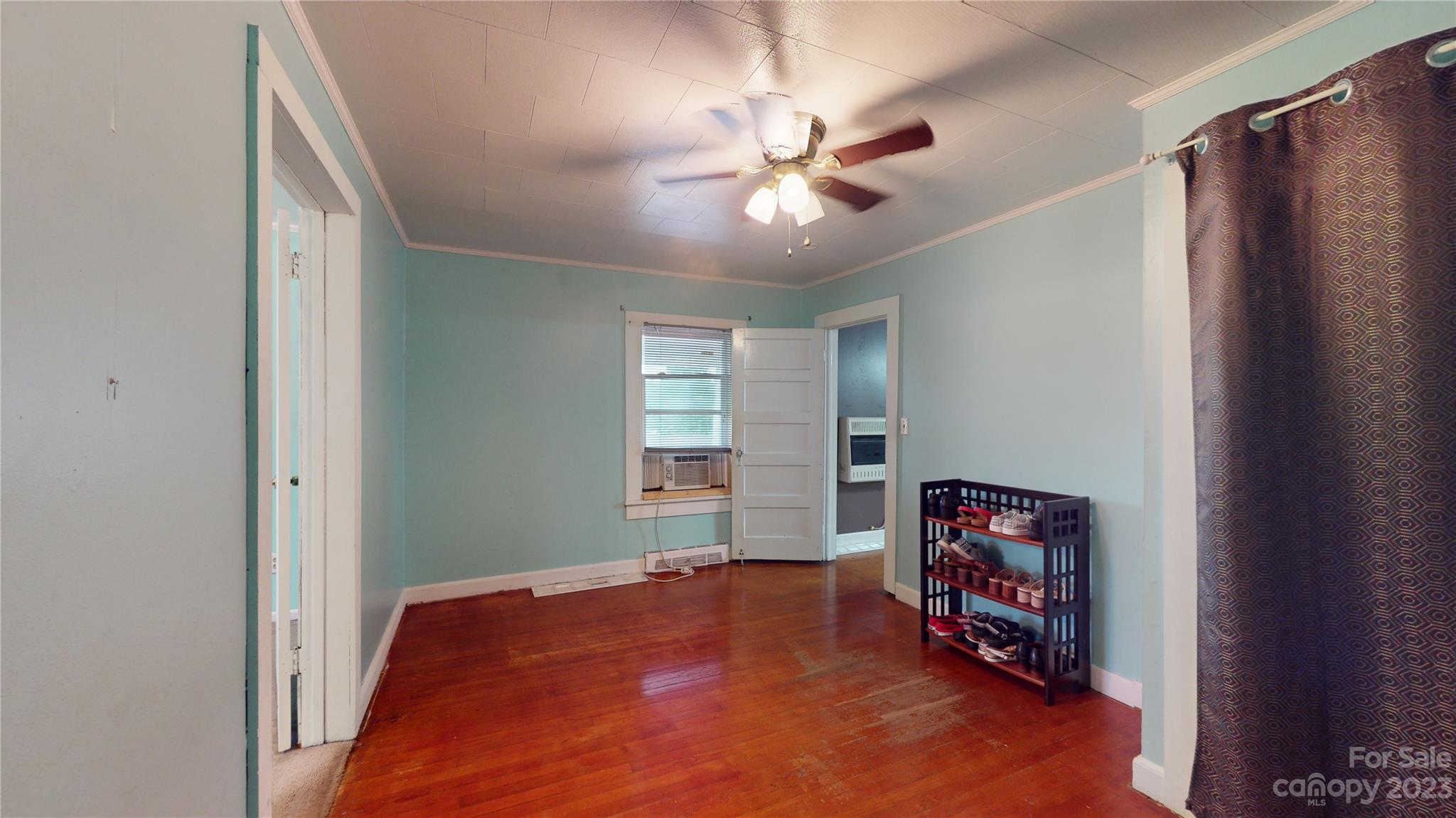 57 Lamar Street Marion, NC 28752 - Photo 19 of 48 a bedroom with a bed and a chandelier