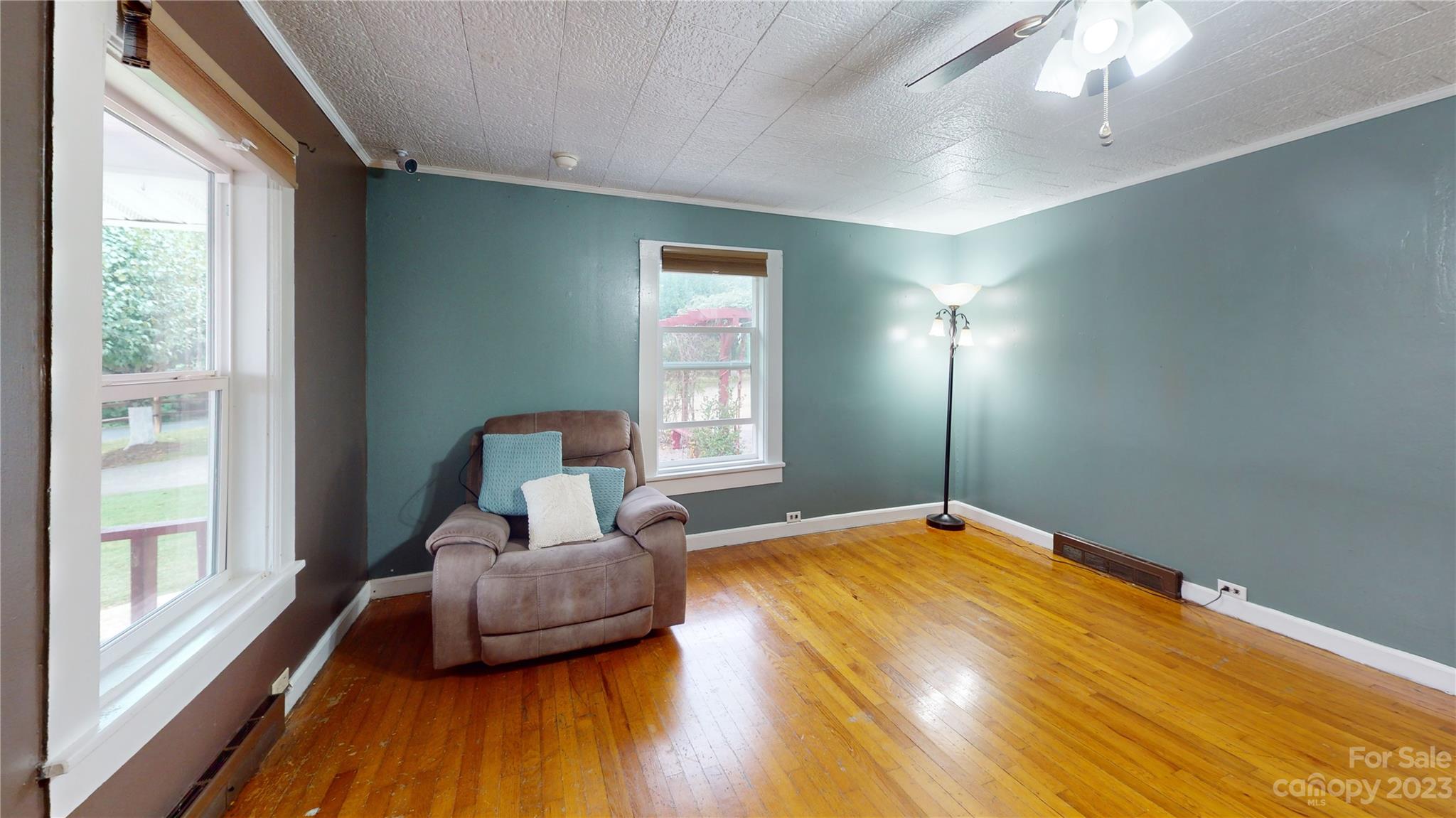 57 Lamar Street Marion, NC 28752 - Photo 35 of 48 a bedroom with a bed and wooden floor