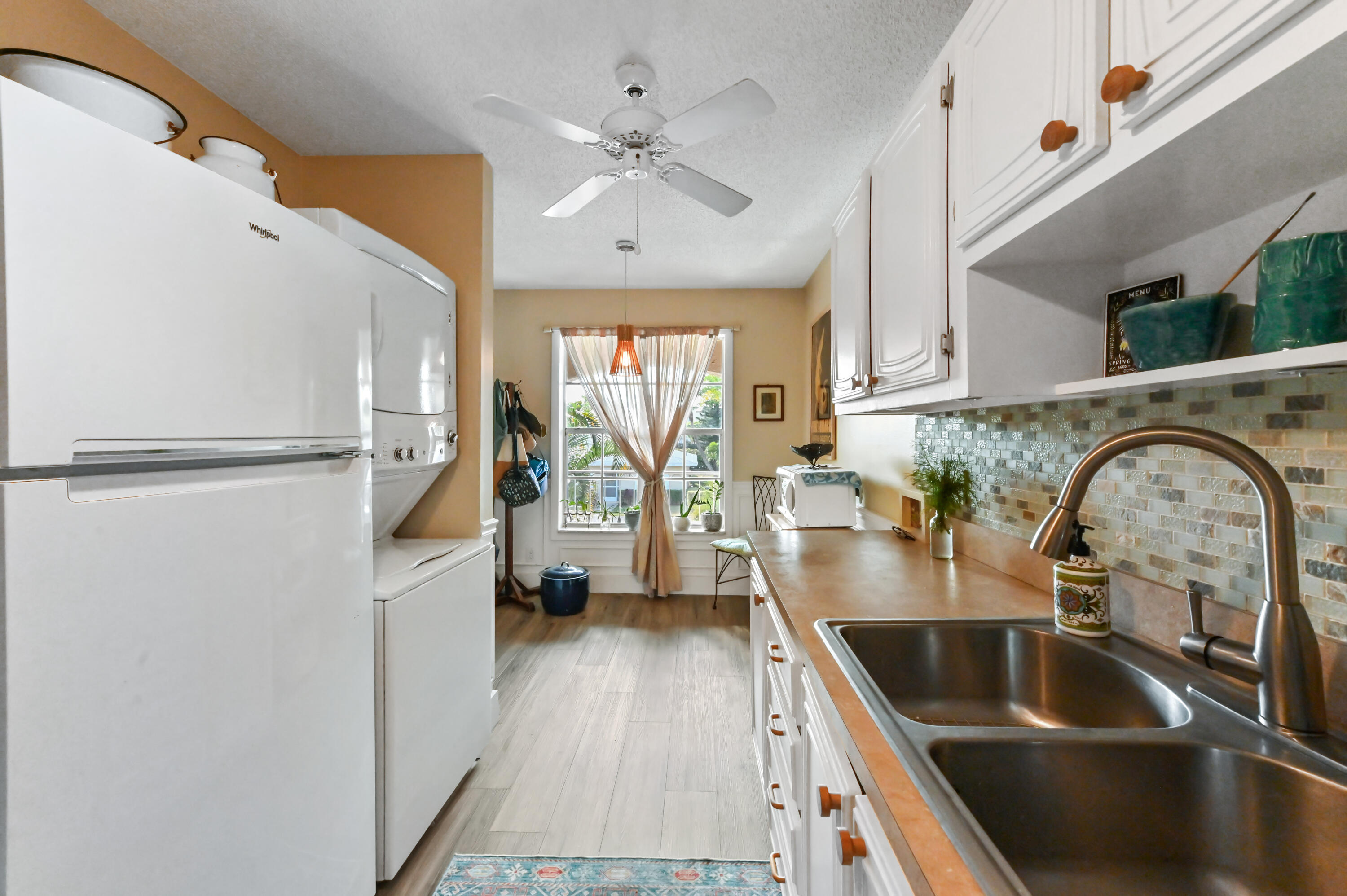 13960 Vía Flora, Unit H Delray Beach, FL 33484 - Photo 12 of 39 a kitchen with a refrigerator and a sink