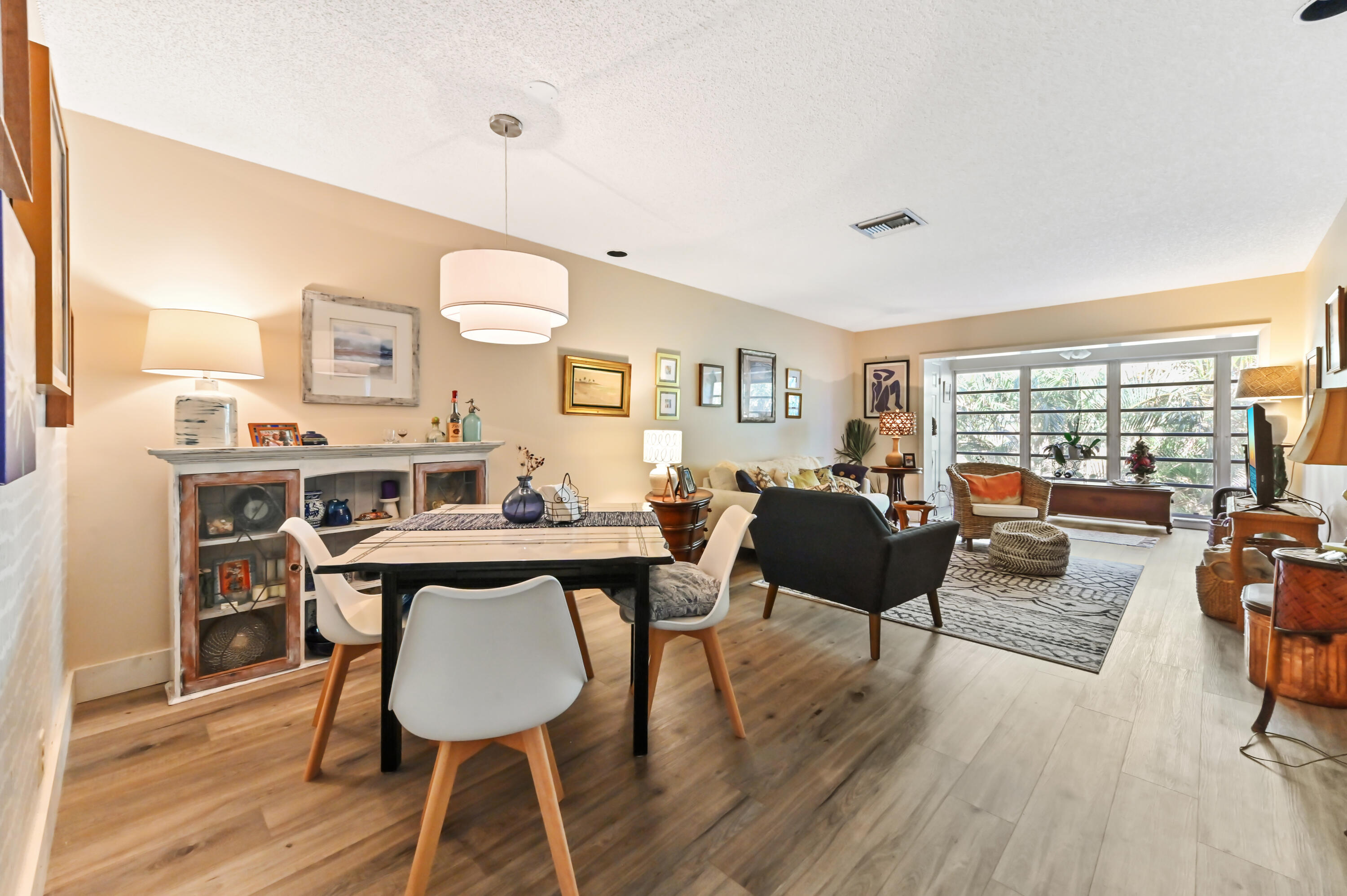 13960 Vía Flora, Unit H Delray Beach, FL 33484 - Photo 13 of 39 a living room with furniture and a wooden floor