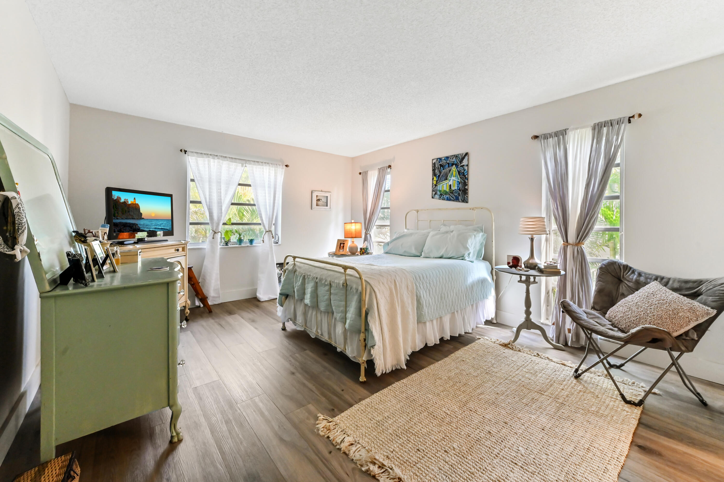 13960 Vía Flora, Unit H Delray Beach, FL 33484 - Photo 21 of 39 a bedroom with a bed and furniture