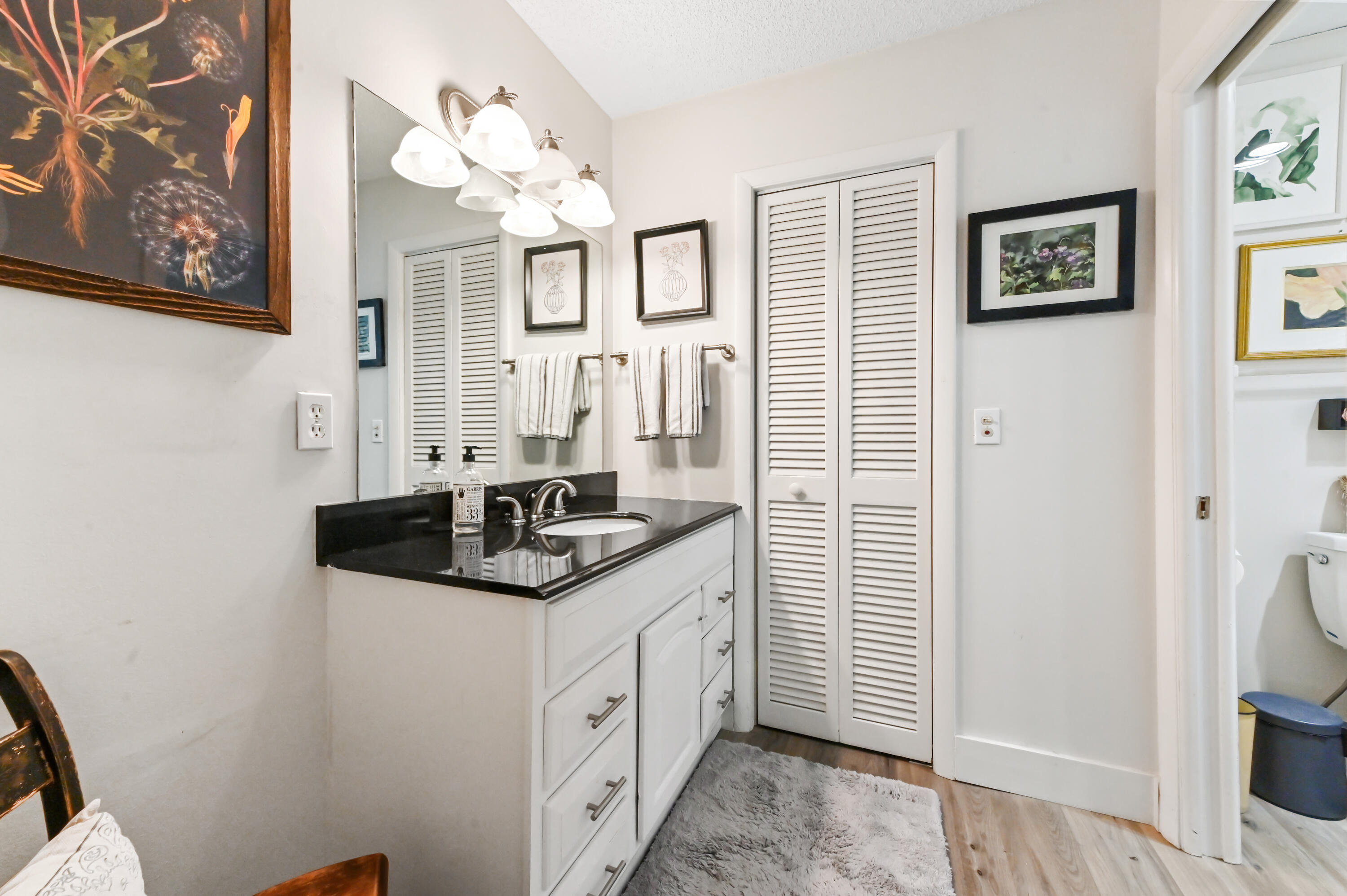 13960 Vía Flora, Unit H Delray Beach, FL 33484 - Photo 24 of 39 a bathroom with a sink a vanity and a mirror