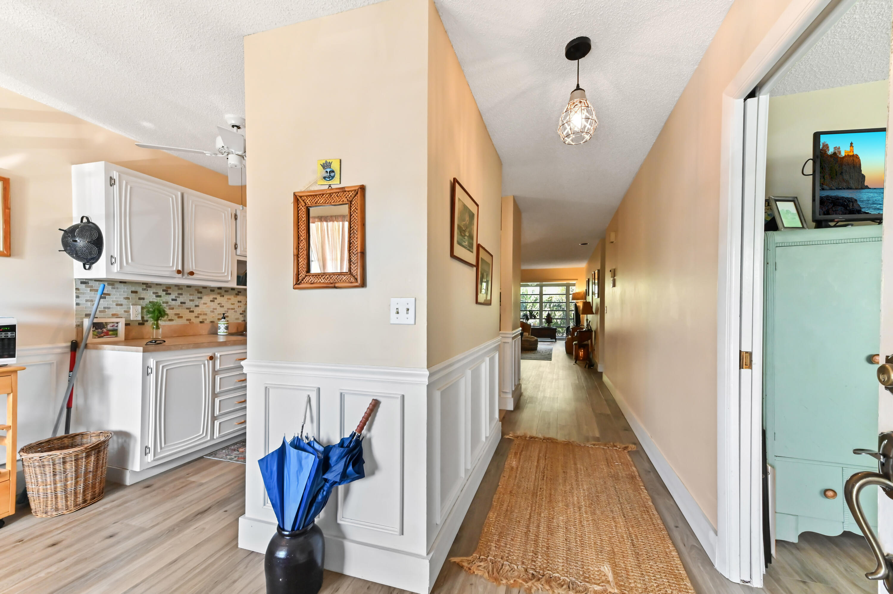 13960 Vía Flora, Unit H Delray Beach, FL 33484 - Photo 5 of 39 a view of a hallway with furniture and wooden floor