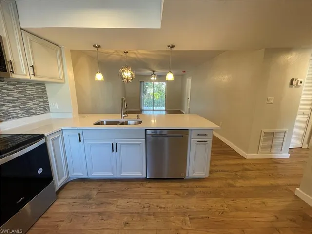 a kitchen with stainless steel appliances granite countertop a sink and a stove