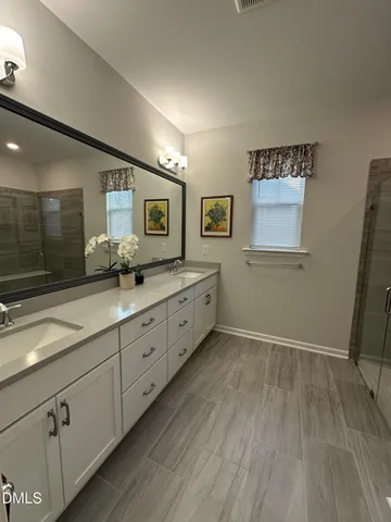 a spacious bathroom with a granite countertop sink mirror and toilet
