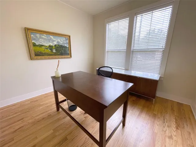 a view of a workspace with furniture and a window