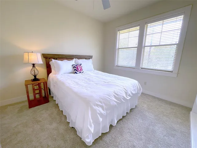 a bedroom with bed and a night stand