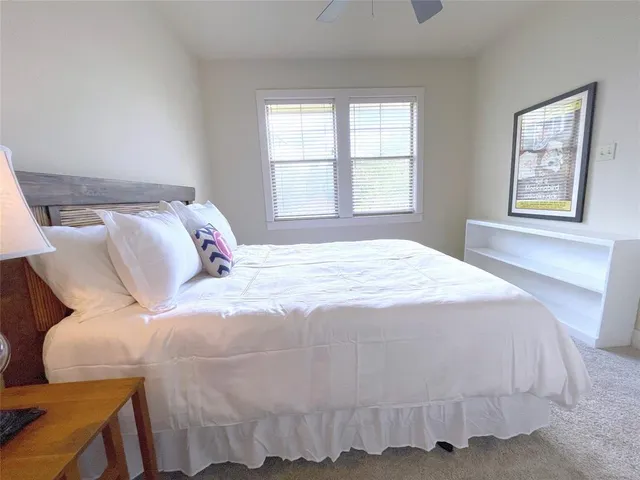 a bedroom with a bed and window