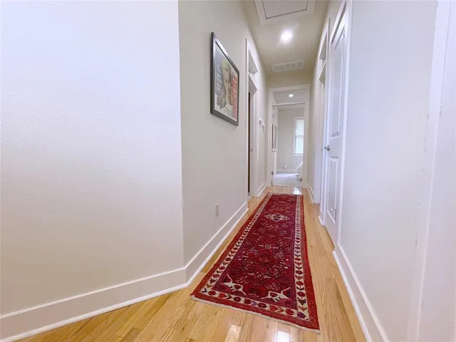 a view of hallway with wooden floor