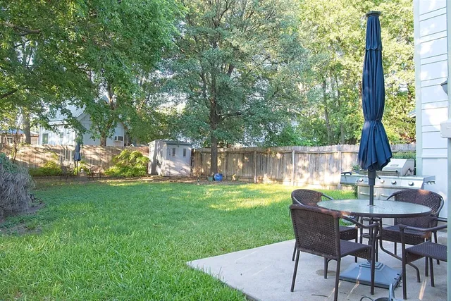 a view of a yard with a table and chairs