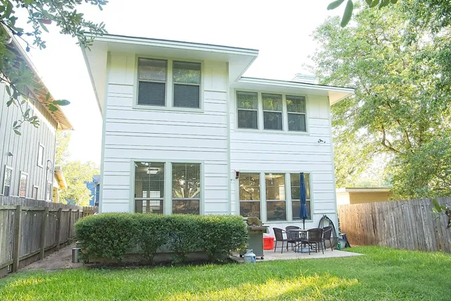 a view of a house with backyard sitting area and garden