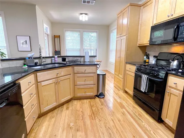 a kitchen with stainless steel appliances granite countertop a stove and a sink