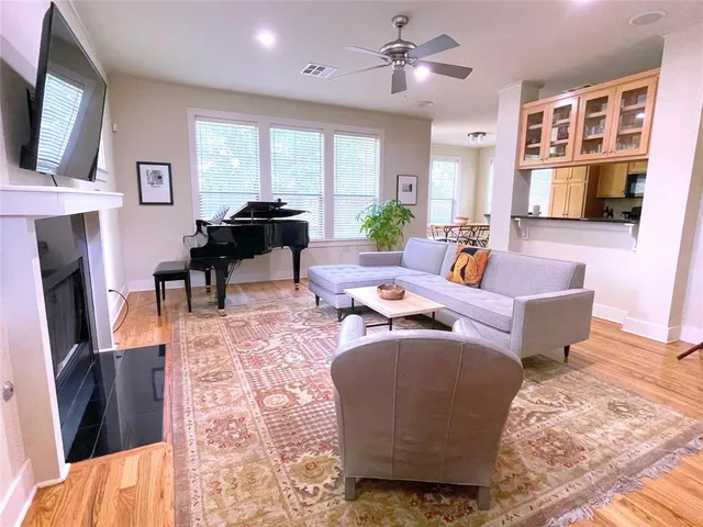 a living room with fireplace furniture and a flat screen tv