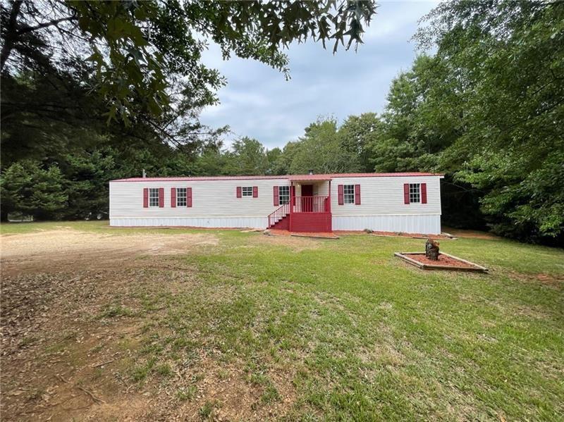 702 Davis Road Lawrenceville, GA 30046 - Photo 1 of 1 a view of a house with a backyard and a tree
