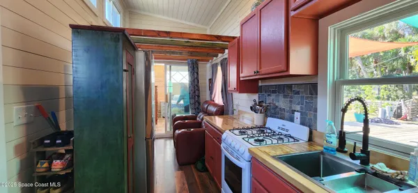 a kitchen with a stove a refrigerator and a sink