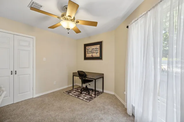 a bed sitting in a bedroom and view of living room
