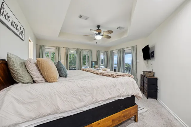 a living room with furniture and a floor to ceiling window