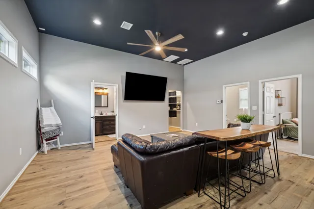 a living room with furniture and a wooden floor