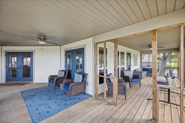 a view of a porch with furniture and a backyard