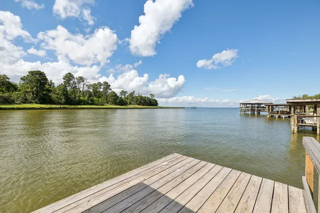 a view of a house with pool and chairs
