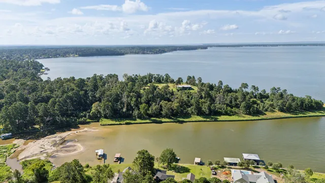 a view of a lake with a house swimming pool and outdoor space