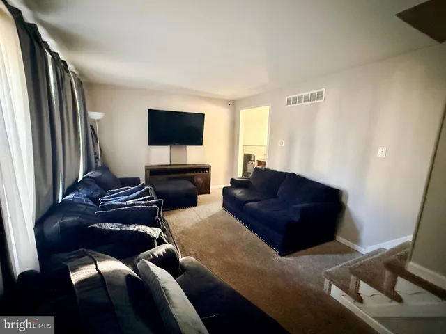 a living room with a couch and a flat screen tv