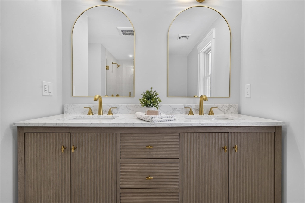 20 Saltonstall Road Medford, MA 02155 - Photo 27 of 41 a bathroom with a double vanity sink and a mirror