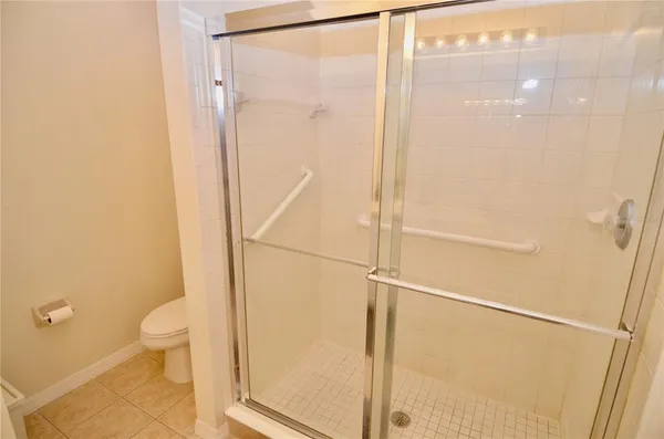 a bathroom with a shower and a toilet