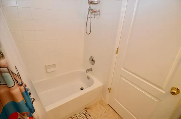 a bathroom with a bath tub with a shower
