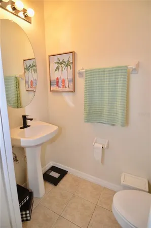 a bathroom with a sink a toilet and mirror