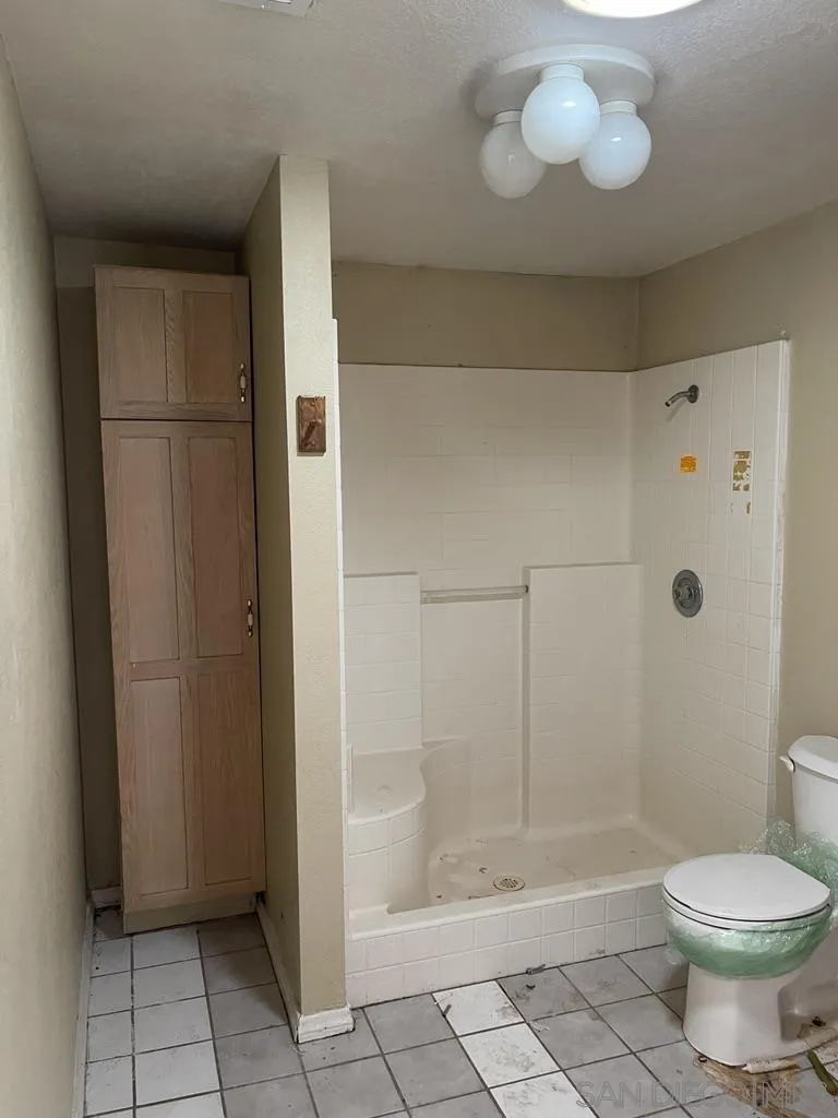 34792 Cedar Road Barstow, CA 92311 - Photo 18 of 26 a bathroom with a toilet and a shower