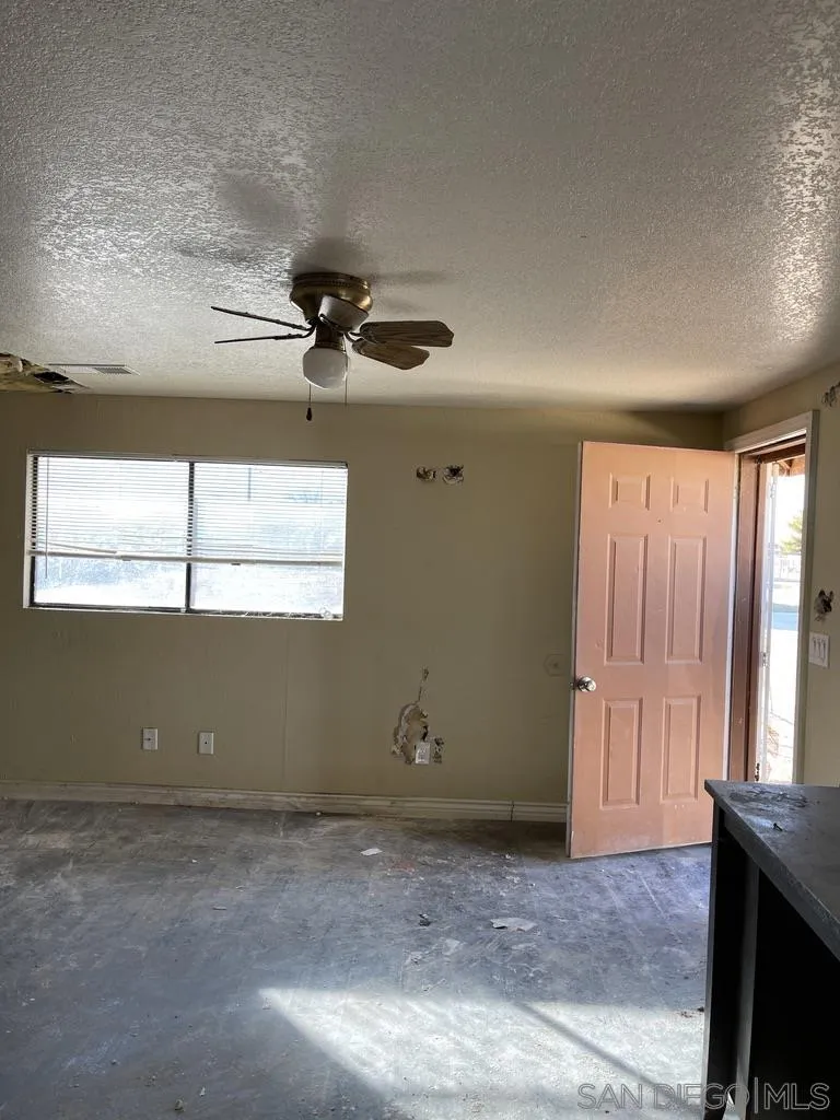 34792 Cedar Road Barstow, CA 92311 - Photo 5 of 26 a view of room with window and ceiling fan