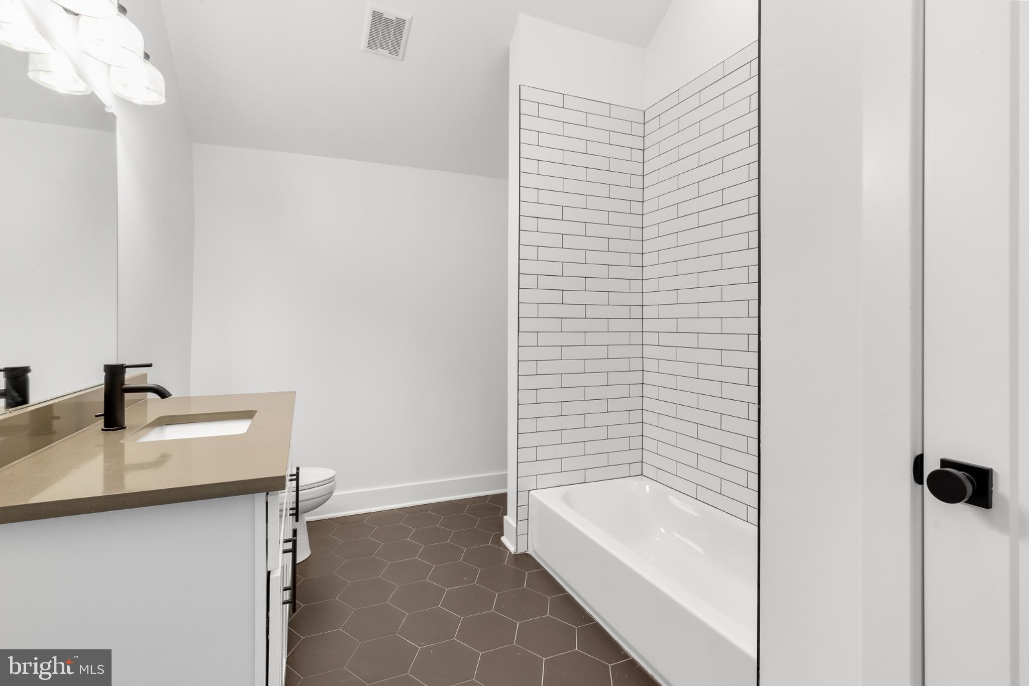 7037 Ridge Avenue, Unit 303 Philadelphia, PA 19128 - Photo 12 of 20 a bathroom with a bathtub and a sink