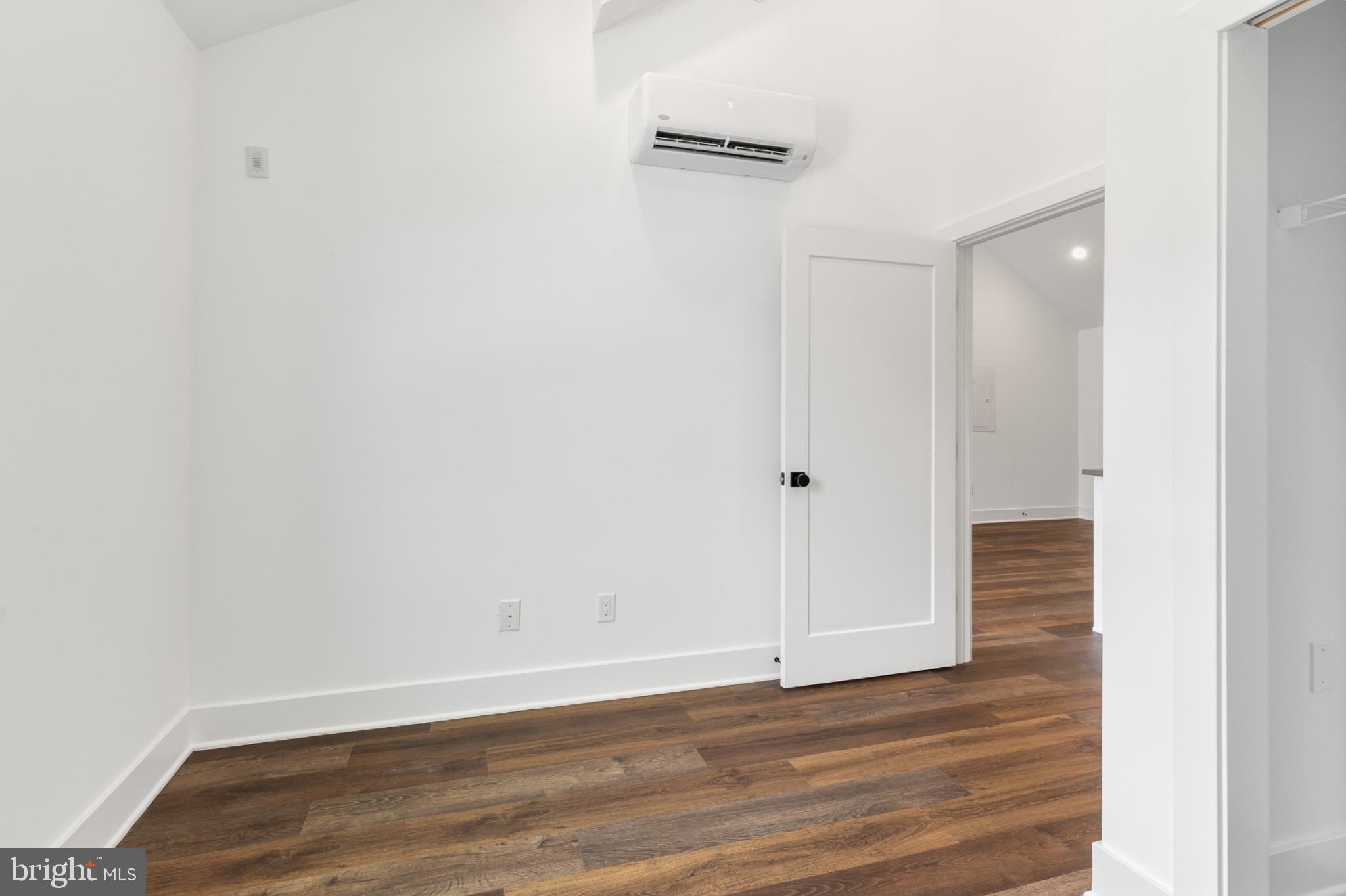 7037 Ridge Avenue, Unit 303 Philadelphia, PA 19128 - Photo 16 of 20 a view of an empty room with wooden floor
