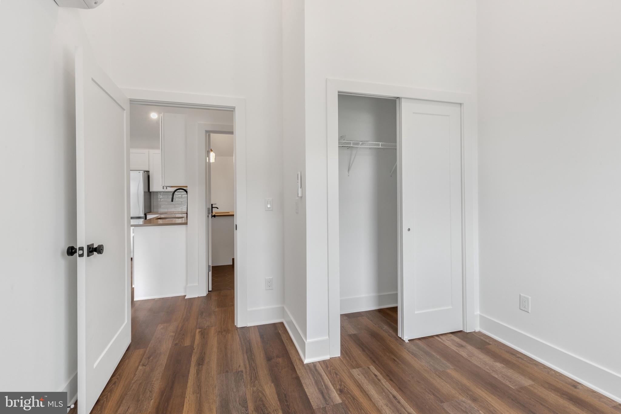 7037 Ridge Avenue, Unit 303 Philadelphia, PA 19128 - Photo 17 of 20 a view of a hallway with wooden floor and a bathroom
