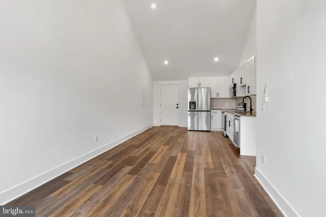 a view of kitchen with wooden floor and electronic appliances