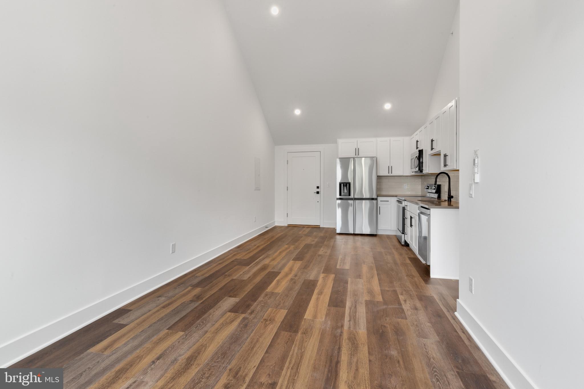 7037 Ridge Avenue, Unit 303 Philadelphia, PA 19128 - Photo 9 of 20 a view of kitchen with wooden floor and electronic appliances
