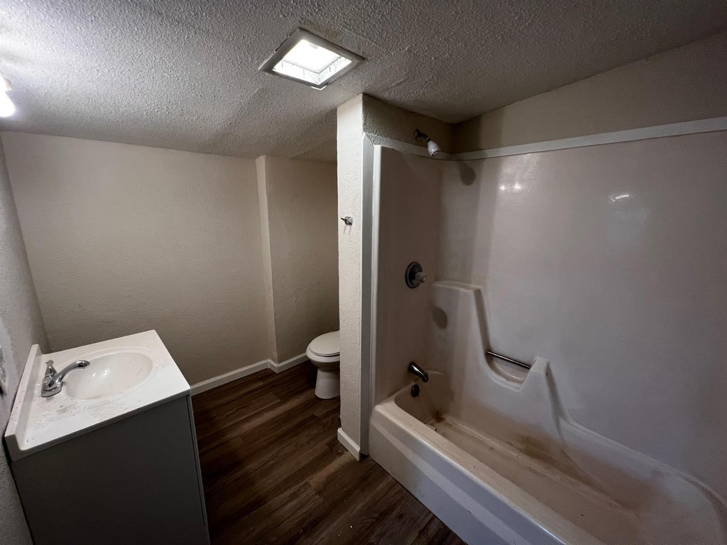 6503 Avenue T Lubbock, TX 79412 - Photo 14 of 15 a bathroom with a sink toilet and shower