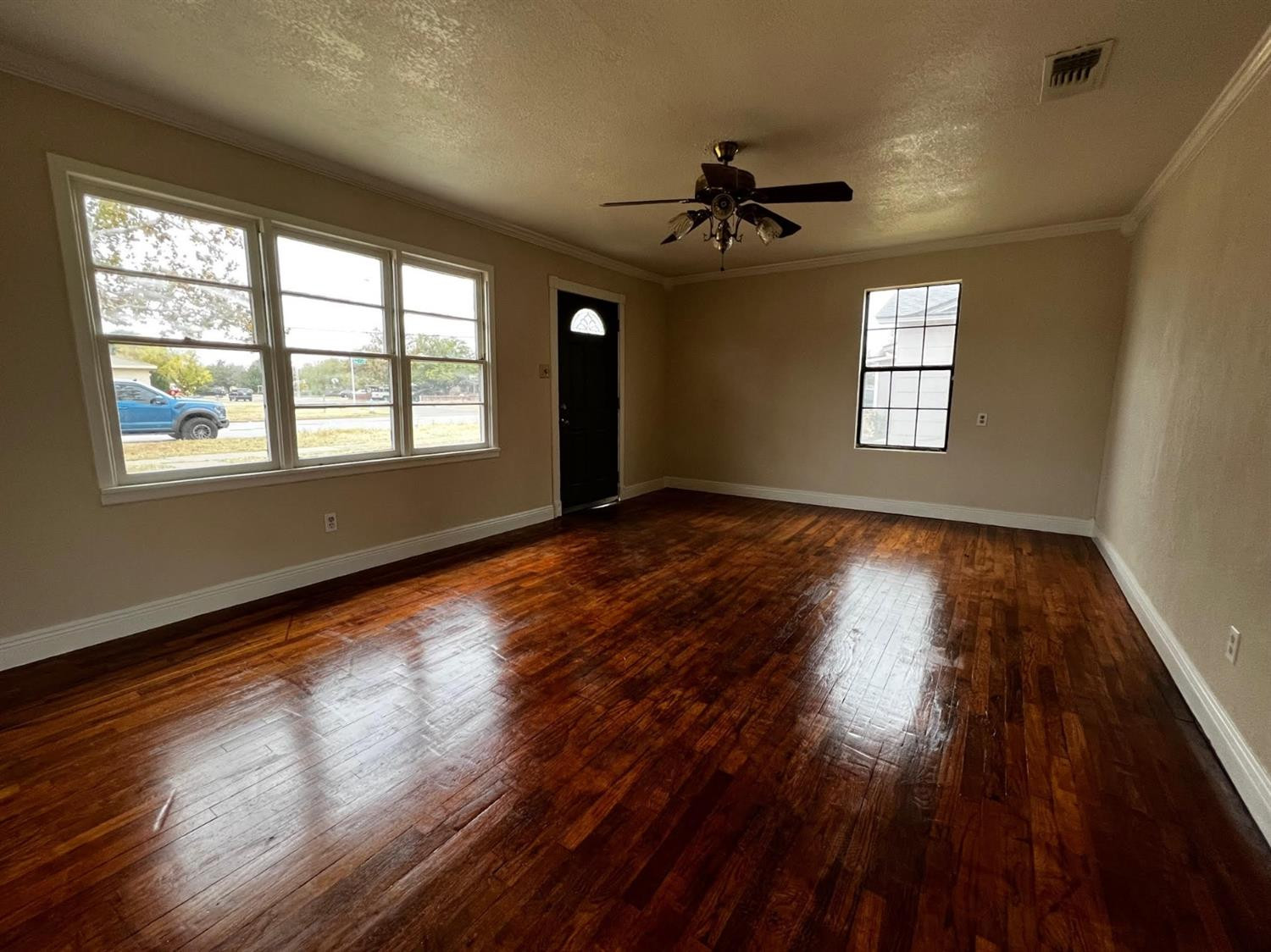 6503 Avenue T Lubbock, TX 79412 - Photo 3 of 15 a view of an empty room with wooden floor and a window
