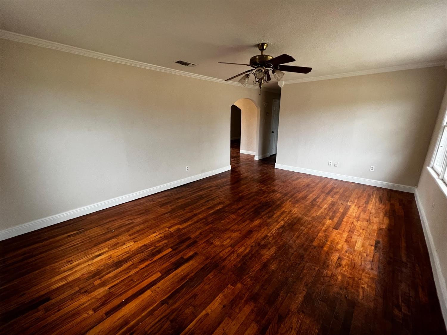 6503 Avenue T Lubbock, TX 79412 - Photo 4 of 15 a view of room with hardwood floor and a ceiling fan