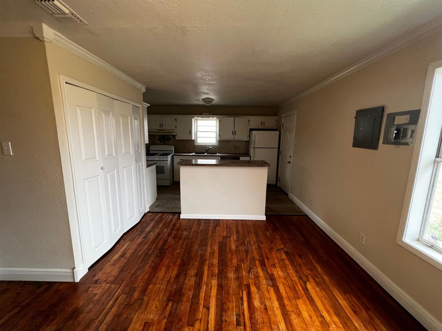 6503 Avenue T Lubbock, TX 79412 - Photo 6 of 15 a kitchen with wooden floors and stainless steel appliances
